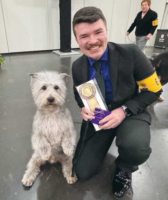 Jonathan Laner and Guerin pose with the ribbon they earned at the 149th annual Westminster Dog Show.