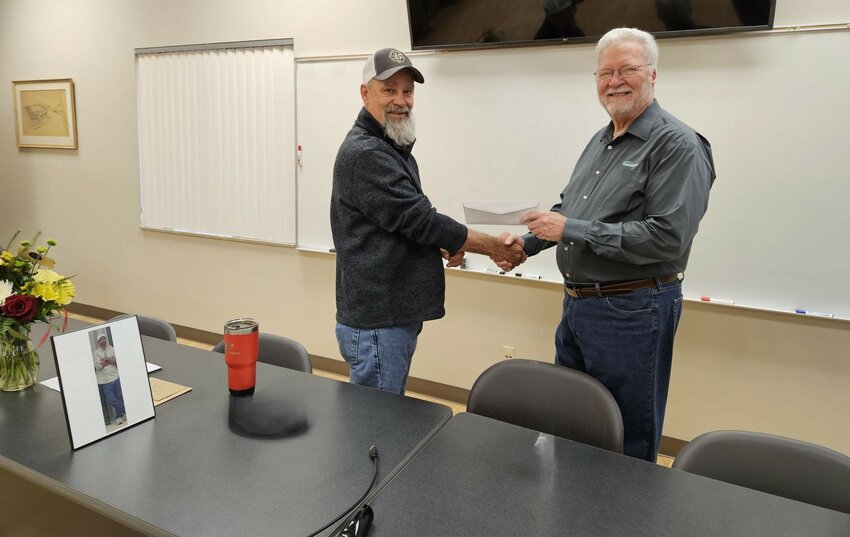 Marty Onnen receives congratulations from Marty Golden on his retirement from Northeast Power