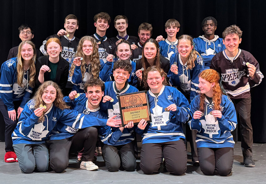 Members of the Wayne High Speech team proudly display the district championship trophy they earned on Saturday.