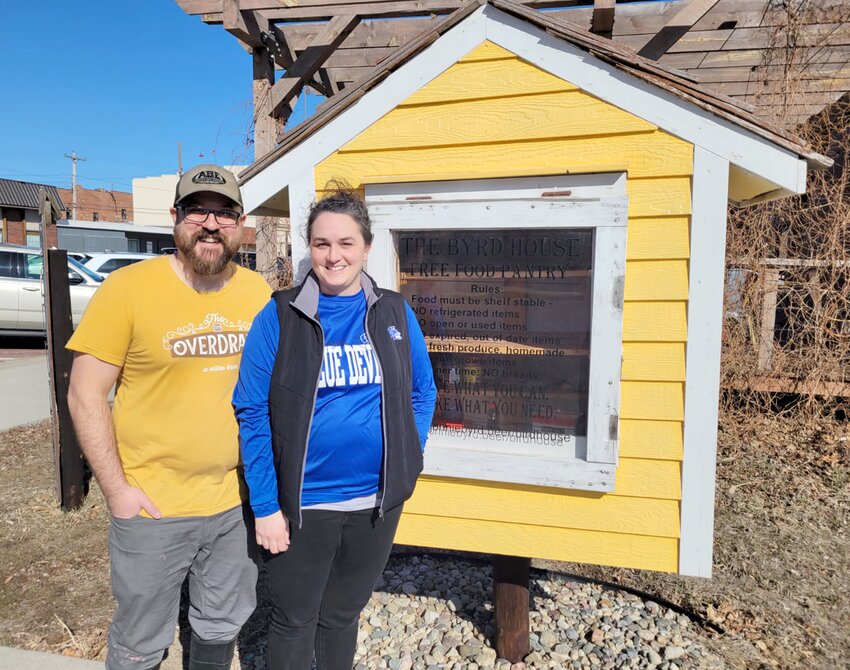 Greg and Kelly Ptacek stand in front of the food pantry located just outside Johnnie Byrd Brewing Company.