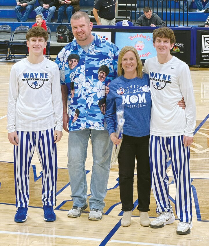 &quot;Brothers&quot; Nacho and Colson pose with their parents, Kyle and Melissa, during Parents' Night at a Wayne High basketball game.