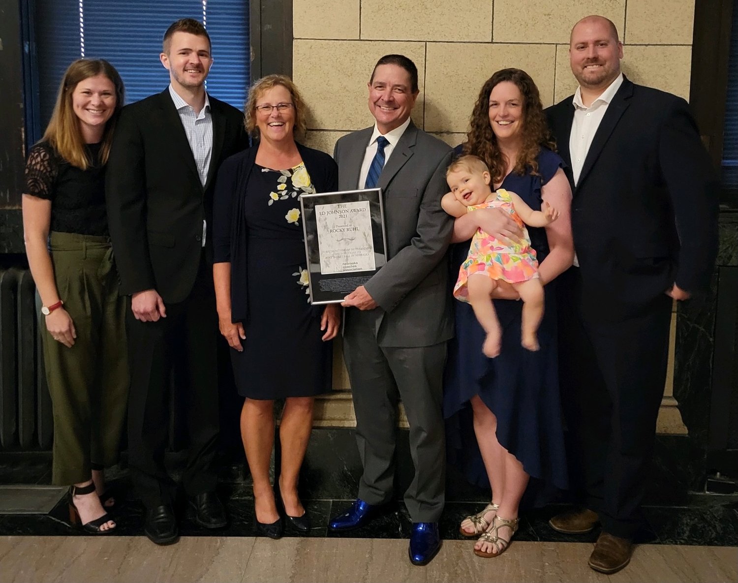 Members of the Ruhl family present at the awards banquet were (left) Halsey and Reggie Ruhl; Sylvia and Rocky;  Regan (holding Brogen) and Nate Ernstmeyer. Also on hand to support Rocky were Duane and Jean Blomenkamp of Wayne. Rocky received the Ed Johnson Award during the 53rd annual Nebraska Coaches Association Awards Banquet in Lincoln on July 25.