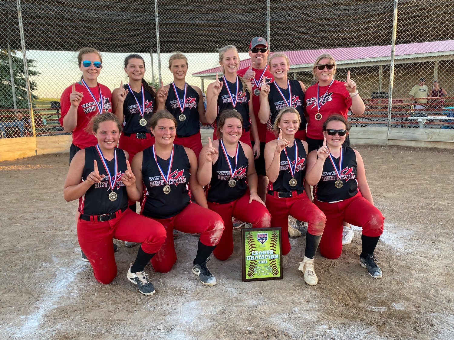 The Wayne Dirt Devils 14-under team won the Logan Valley League tournament title with an exciting, come-from-behind win over the Fremont Force, scoring two in the bottom of the sixth to win 3-2. (front) Lily Gubbels, Sammi Gubbels, Caitlyn Mostek, Kierah Haase, Carli Canham, (back) coach Sidney Biggerstaff, Tatum Ellis, Jersi Jensen, Delaney Kruse, coach Brandon Hall, Rylin Hall and coach Annie Knieche.