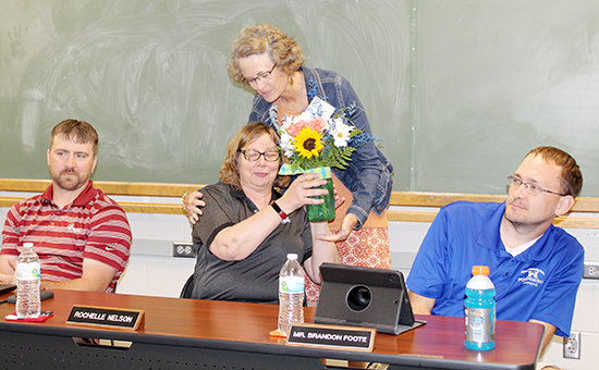 Wayne Community Schools' Board of Education member Jodi Pulfer presented a bouquet of flowers as a thank you for her years of service to the district.