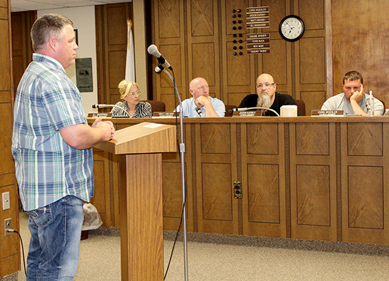 Brett Davis with Waste Connections of Nebraska (left) was present at Tuesday's City Council meeting to answer questions in regard to the contract between the city and his business.