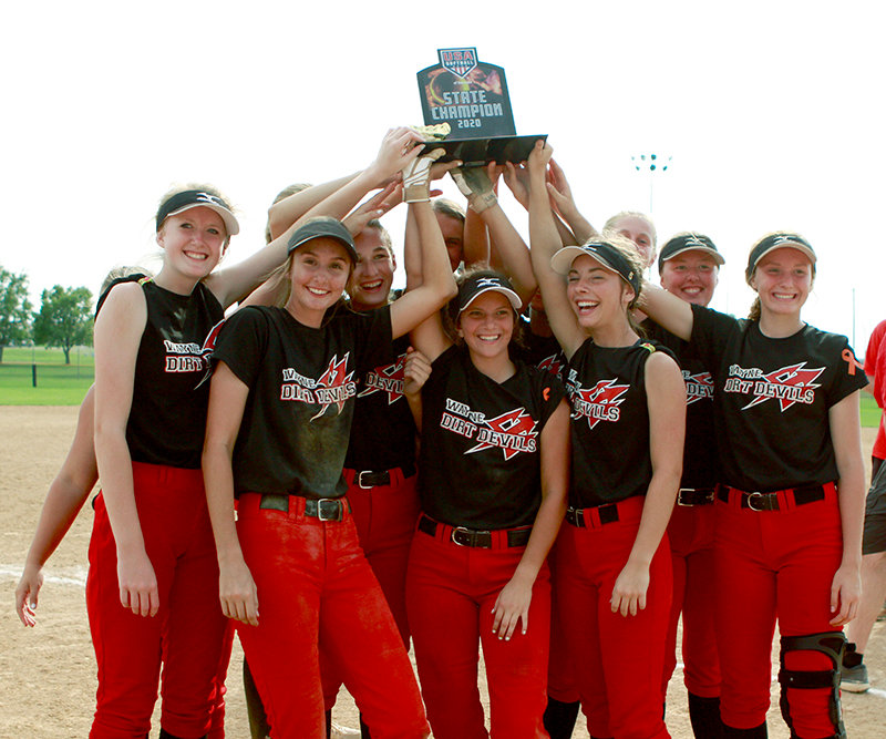 Members of the Wayne Dirt Devils 16/18-under team hoist the championship trophy after winning the USSSA Class C state title Sunday afternoon in Hastings. (Photo by Michael Carnes)