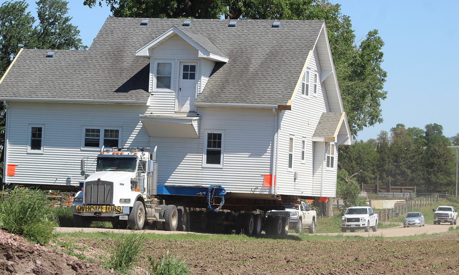 A house once located northeast of Wayne makes its way down country roads on Thursday.