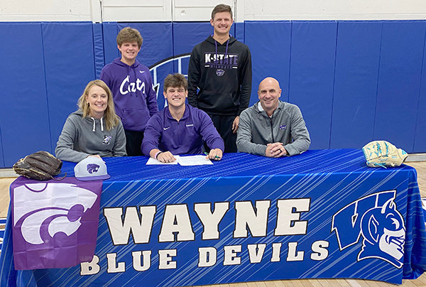 Brooks Kneifl (center) signed a scholarship offer to play baseball at Kansas State University last week. With him are his parents, Jen and Scott, and brothers (back) Jaxon and Jacob.