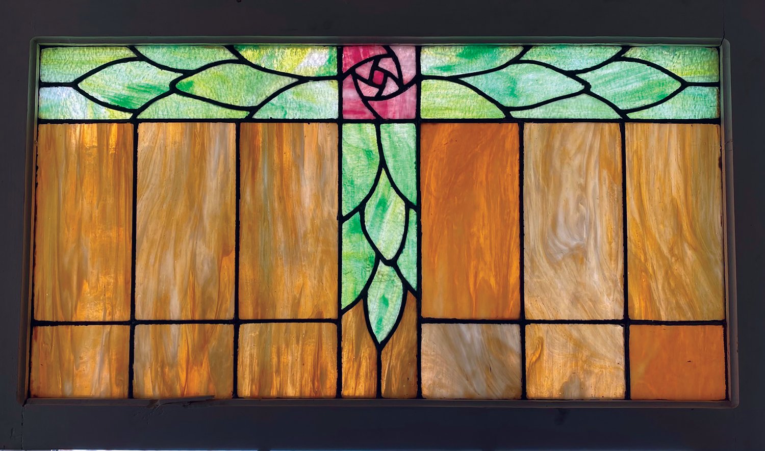 This stained-glass window features a mackintosh rose, which is in the Rose Cottage's logo.